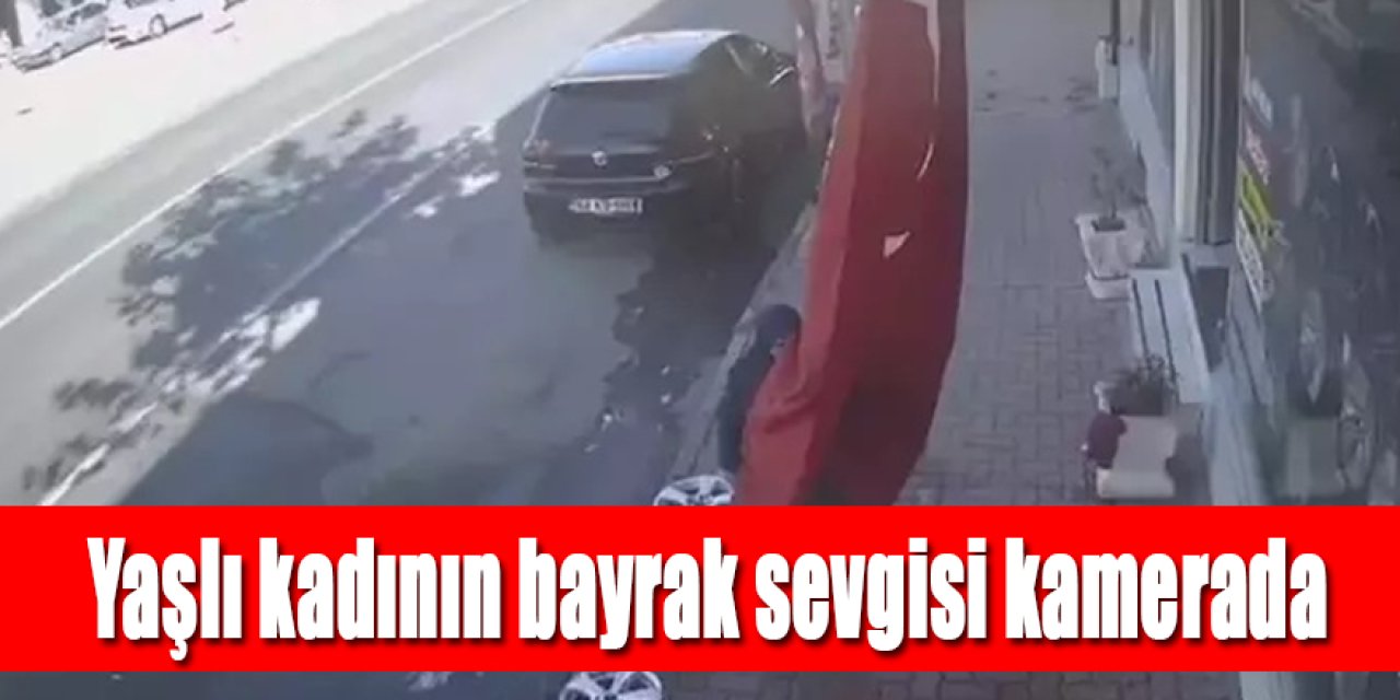 Bastonla yürüyen kadının iş yeri önündeki bayrağı öpmesi kamerada
